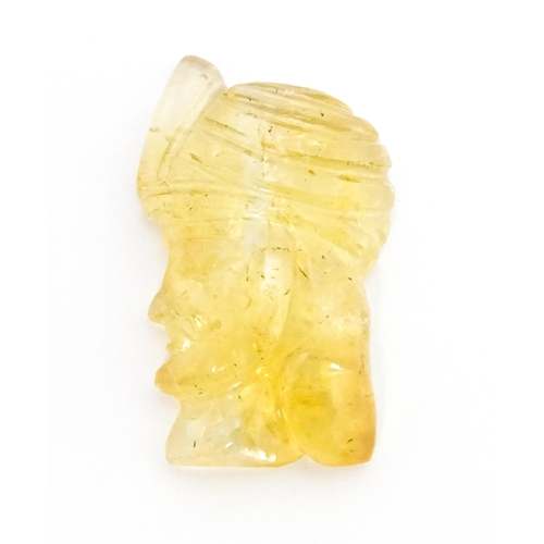 737 - A citrine intaglio carved to form the head in profile of a man wearing a turban. Approx 1