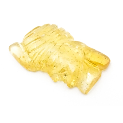 737 - A citrine intaglio carved to form the head in profile of a man wearing a turban. Approx 1