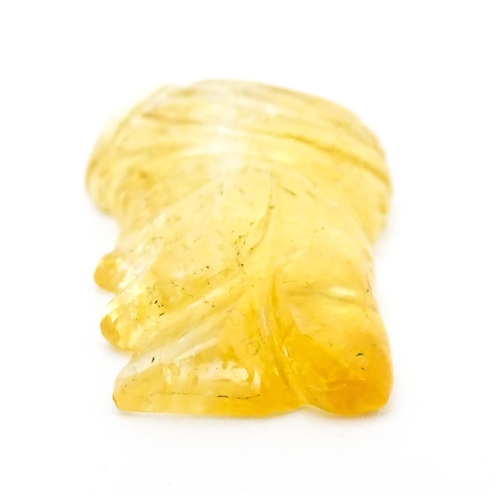 737 - A citrine intaglio carved to form the head in profile of a man wearing a turban. Approx 1