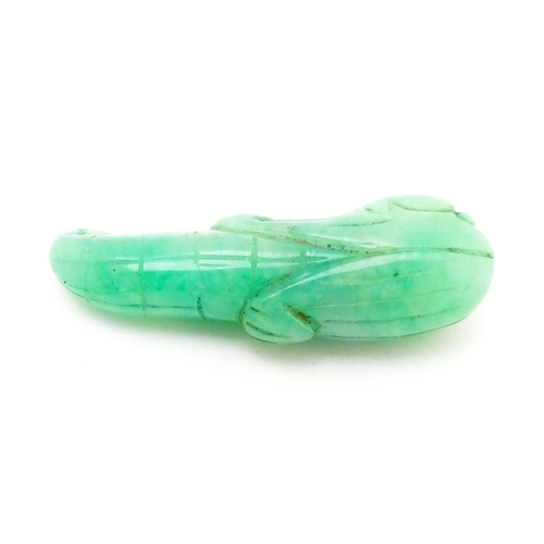 739 - An Oriental carved jade pendant modelled as corn on the cob. 1 3/4