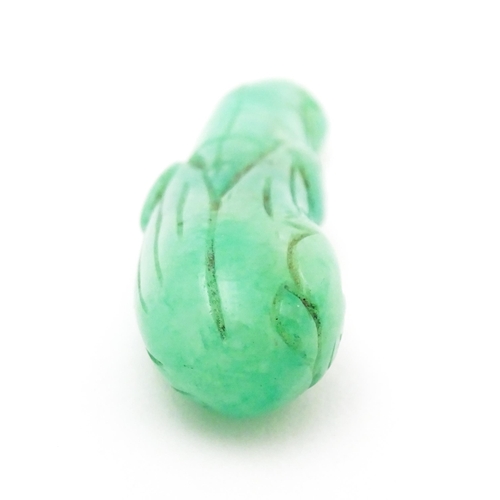 739 - An Oriental carved jade pendant modelled as corn on the cob. 1 3/4