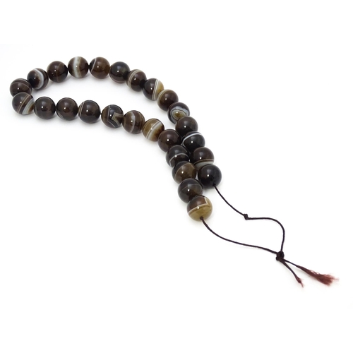 742 - A string of Scottish agate beads with banded decoration. The largest approx 5/8