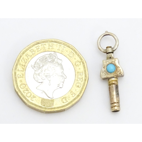 775 - A gilt metal pocket watch key set with turquoise cabochon. Approx. 1