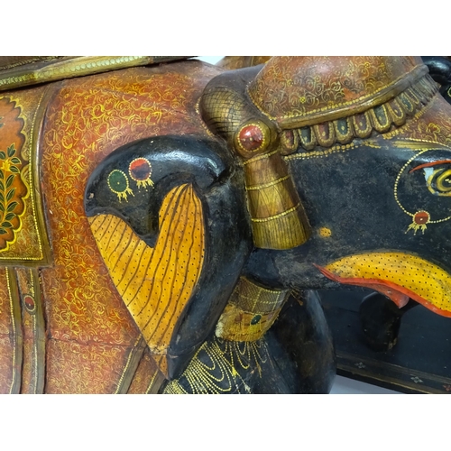 1304 - Two large Kashmir wooden models of elephants with polychrome decoration raised on rectangular bases.... 