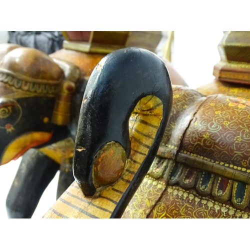 1304 - Two large Kashmir wooden models of elephants with polychrome decoration raised on rectangular bases.... 