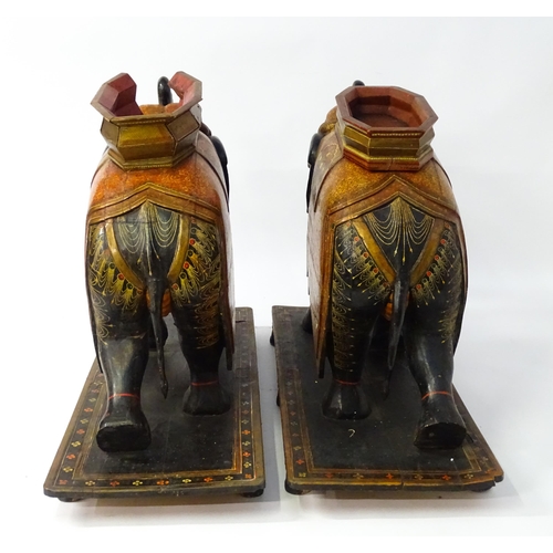 1304 - Two large Kashmir wooden models of elephants with polychrome decoration raised on rectangular bases.... 