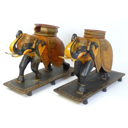 1304 - Two large Kashmir wooden models of elephants with polychrome decoration raised on rectangular bases.... 