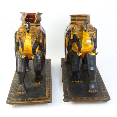 1304 - Two large Kashmir wooden models of elephants with polychrome decoration raised on rectangular bases.... 