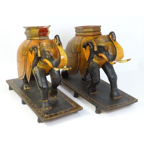 1304 - Two large Kashmir wooden models of elephants with polychrome decoration raised on rectangular bases.... 