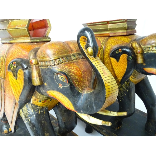 1304 - Two large Kashmir wooden models of elephants with polychrome decoration raised on rectangular bases.... 