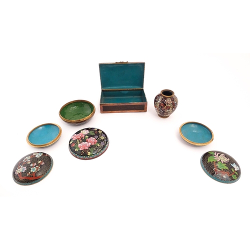 1059 - Five assorted items of Oriental black ground cloisonne comprising a box of rectangular form with flo... 