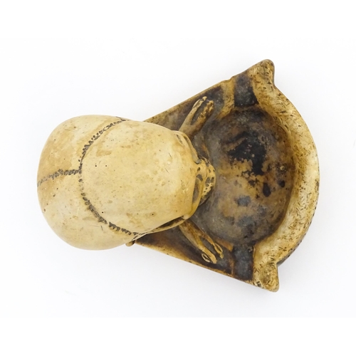 1174 - A 20thC composite Memento Mori ashtray with skull and crossed bone detail. Approx. 4