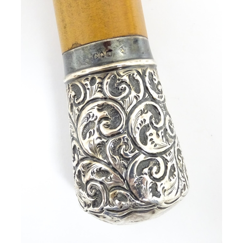 1298A - A Victorian malacca walking stick / cane with silver top decorated with embossed acanthus scroll det... 