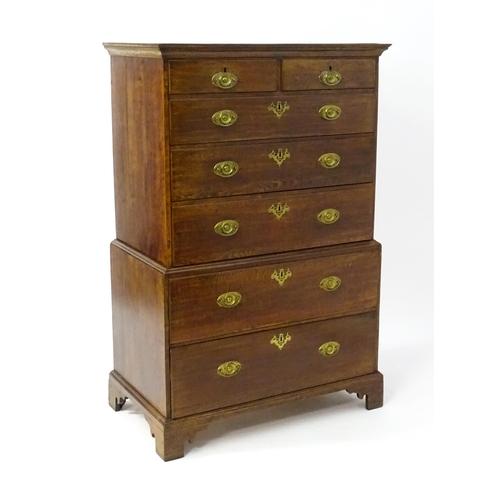 1448 - A late 19thC oak chest on chest, with a moulded cornice above two short over five graduated drawers ... 