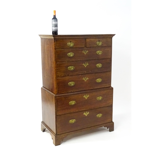 1448 - A late 19thC oak chest on chest, with a moulded cornice above two short over five graduated drawers ... 