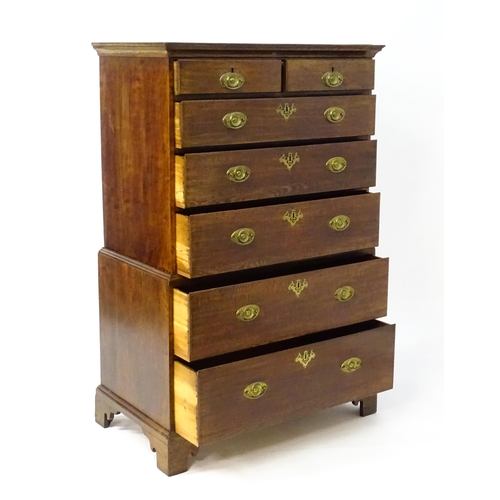 1448 - A late 19thC oak chest on chest, with a moulded cornice above two short over five graduated drawers ... 