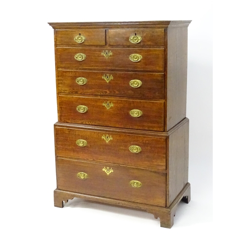 1448 - A late 19thC oak chest on chest, with a moulded cornice above two short over five graduated drawers ... 