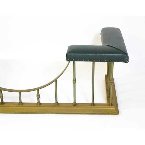 1460 - A late 20thC club fender, with two leather upholstered seats raised on brass railed supports and a s... 