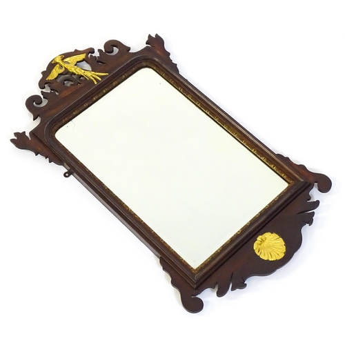 1533 - A late 19thC / early 20thC mahogany mirror, with a pierced frame and gilt painted shell and hoho bir... 