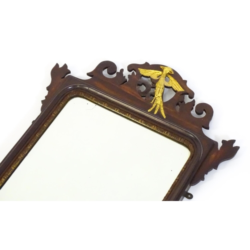 1533 - A late 19thC / early 20thC mahogany mirror, with a pierced frame and gilt painted shell and hoho bir... 