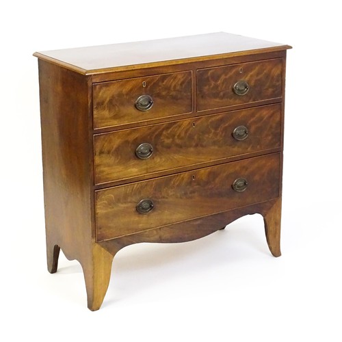 1487 - An early / mid 19thC mahogany chest of drawers comprising two short over two long drawers and raised... 