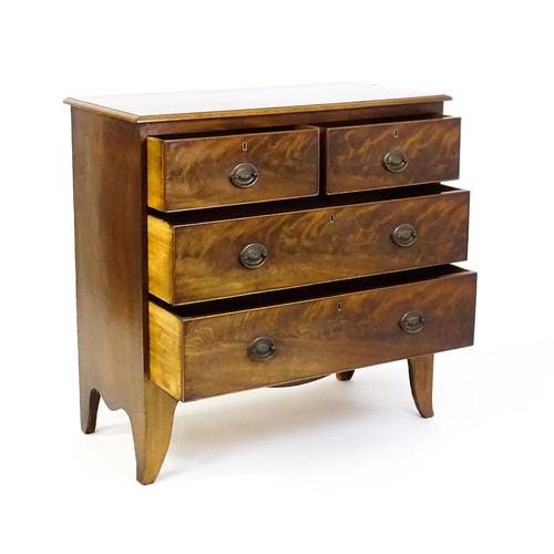 1487 - An early / mid 19thC mahogany chest of drawers comprising two short over two long drawers and raised... 