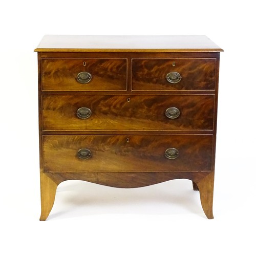 1487 - An early / mid 19thC mahogany chest of drawers comprising two short over two long drawers and raised... 