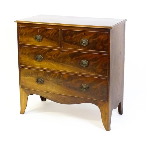 1487 - An early / mid 19thC mahogany chest of drawers comprising two short over two long drawers and raised... 