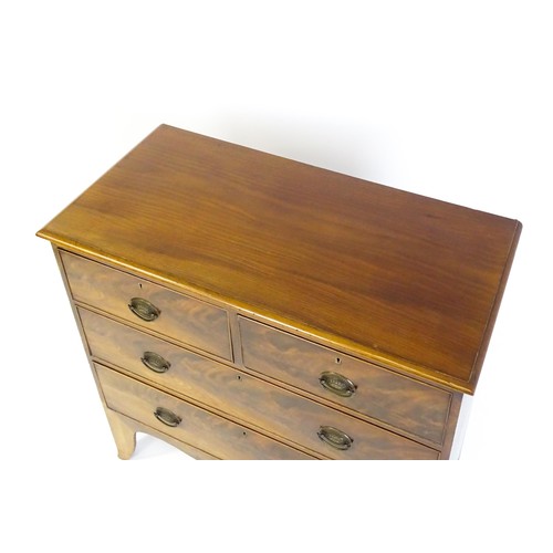 1487 - An early / mid 19thC mahogany chest of drawers comprising two short over two long drawers and raised... 