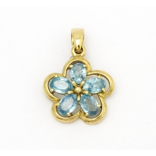 707 - A 9ct gold pendant set with zircons in a floral setting. Approx. 11