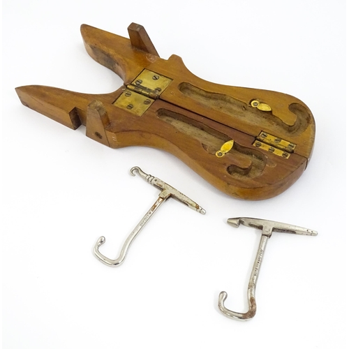 1192 - An early 20thC folding boot jack opening to reveal a pair of steel boot / button hook tools. Approx.... 