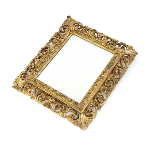 1482 - An early 20thC giltwood and gesso mirror with a pierced surround.  13