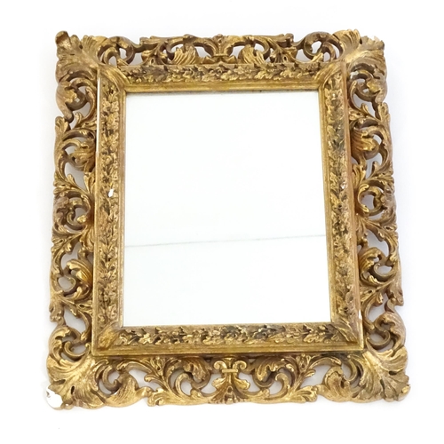 1482 - An early 20thC giltwood and gesso mirror with a pierced surround.  13