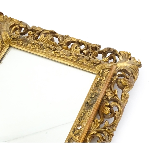 1482 - An early 20thC giltwood and gesso mirror with a pierced surround.  13