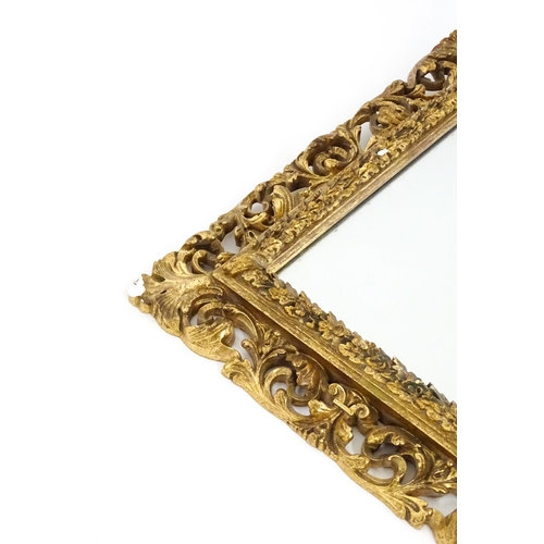 1482 - An early 20thC giltwood and gesso mirror with a pierced surround.  13