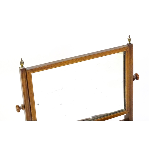 1537 - A 19thC mahogany toilet mirror with decorative inlay and three short drawers. 22