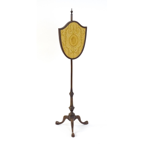 1618 - An early 20thC  pole screen with a shield shape embroidery raised on a turned pole and three cabriol... 