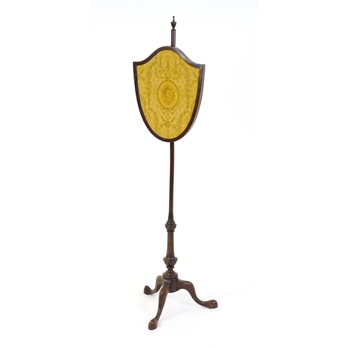 1618 - An early 20thC  pole screen with a shield shape embroidery raised on a turned pole and three cabriol... 