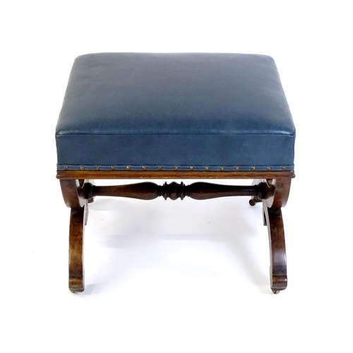 1436 - A Victorian 19thC mahogany Gothic stool, the leather upholstered seat raised on an x-frame base with... 