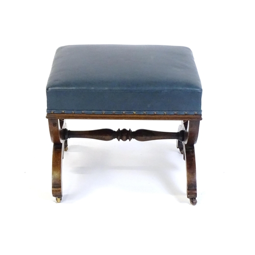 1436 - A Victorian 19thC mahogany Gothic stool, the leather upholstered seat raised on an x-frame base with... 