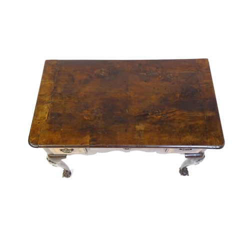 1443 - An 18thC walnut low boy with a moulded and cross banded top above three short drawers with a shaped ... 