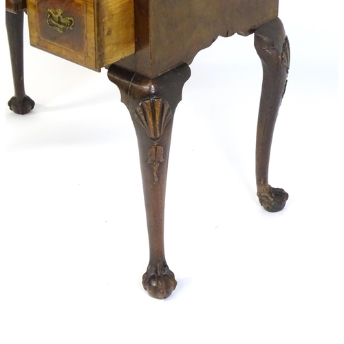 1443 - An 18thC walnut low boy with a moulded and cross banded top above three short drawers with a shaped ... 