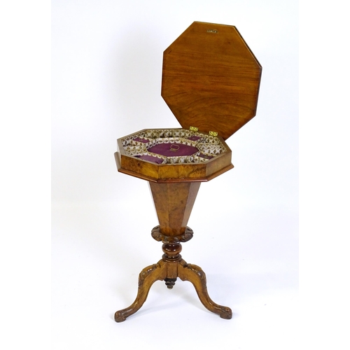 1468 - A Victorian walnut sewing table, with a moulded octagonal top, trumped shaped pedestal with carved d... 