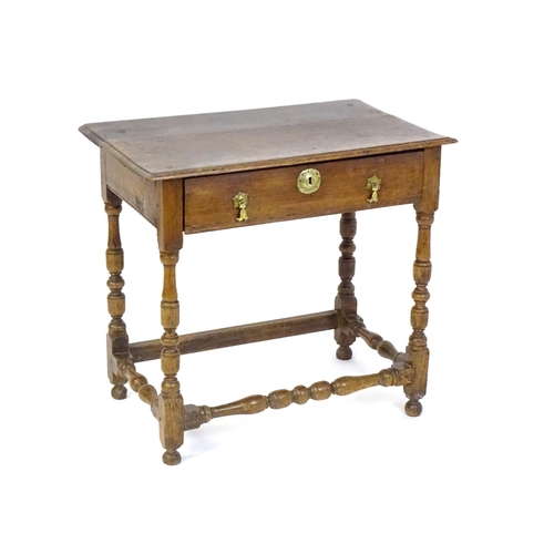 1469 - An 18thC oak side table with a moulded top above a single long frieze drawer, the table raised on tu... 