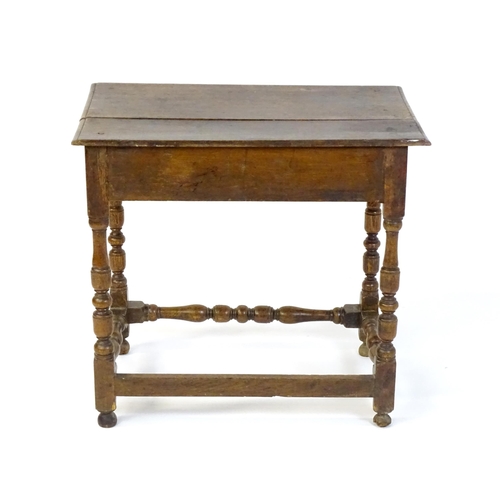 1469 - An 18thC oak side table with a moulded top above a single long frieze drawer, the table raised on tu... 