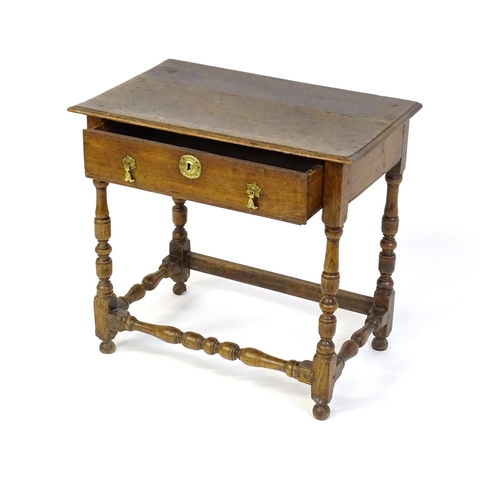 1469 - An 18thC oak side table with a moulded top above a single long frieze drawer, the table raised on tu... 