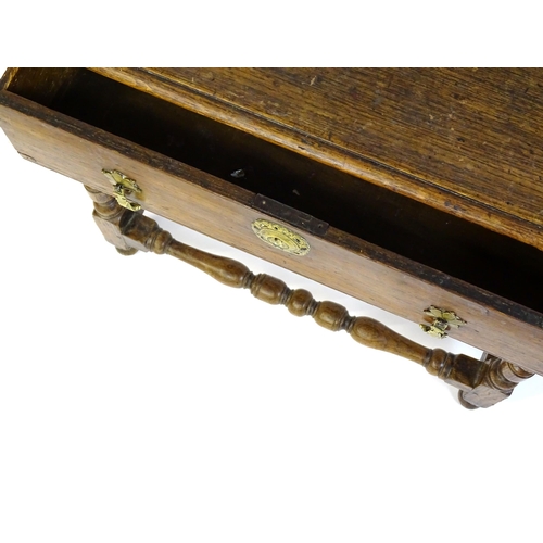 1469 - An 18thC oak side table with a moulded top above a single long frieze drawer, the table raised on tu... 