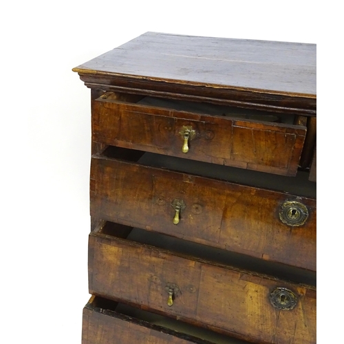 1479 - An early / mid 18thC oak and walnut chest of drawers, the moulded top above two short over three lon... 