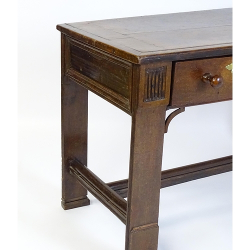 1481 - A Georgian oak two drawer table with a rectangular top above two short drawers with turned knob hand... 