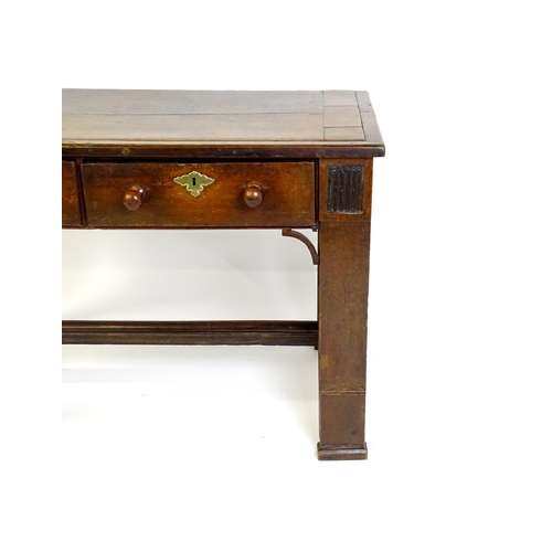 1481 - A Georgian oak two drawer table with a rectangular top above two short drawers with turned knob hand... 
